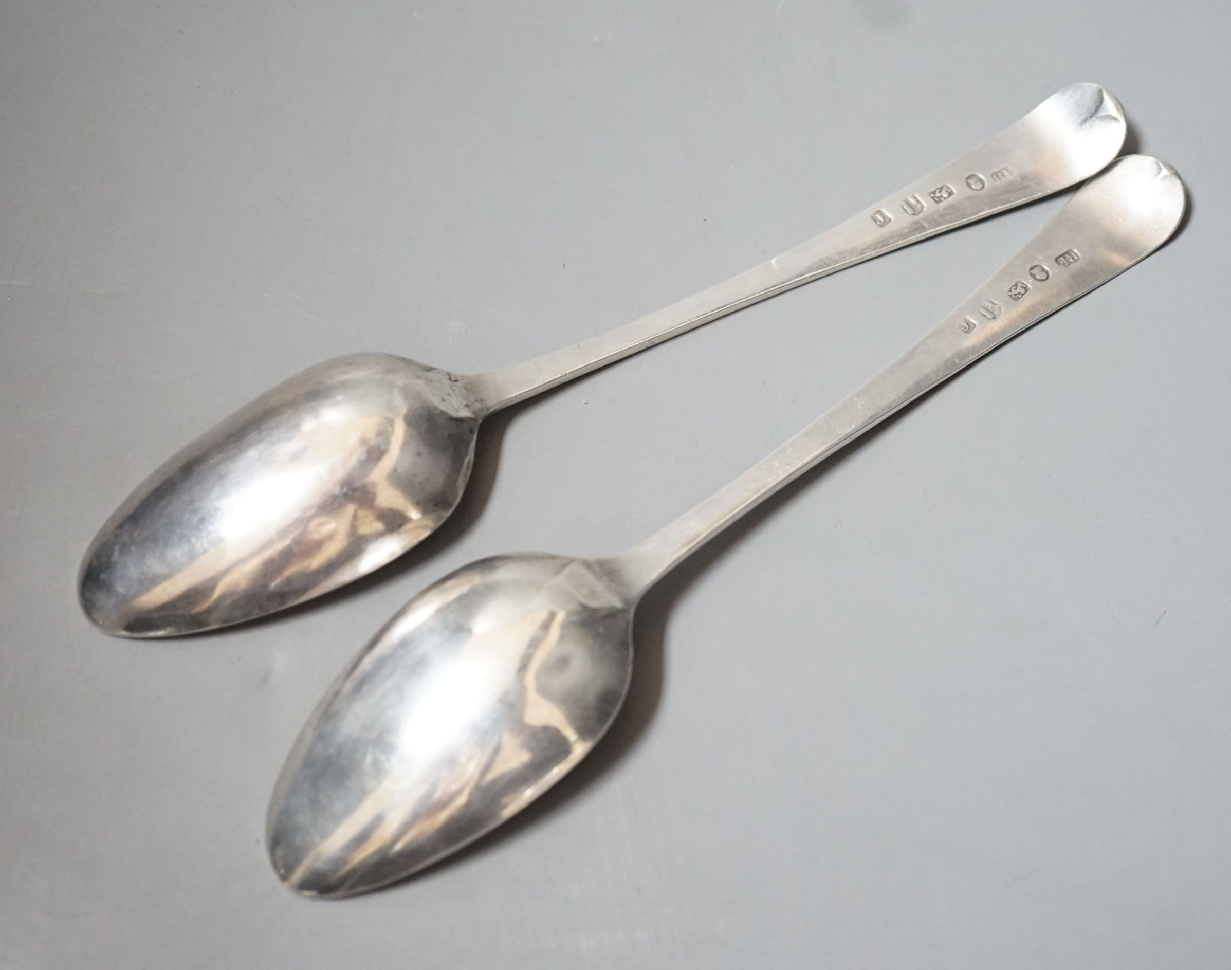 A near pair of George III provincial silver Old English pattern table spoons, by Richard Ferris, Exeter, 1791, with differing bright engraving and one with engraved date and initials, 21.4cm, 110 grams